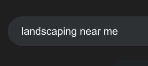 Search bar with the query landscaping near me typed in