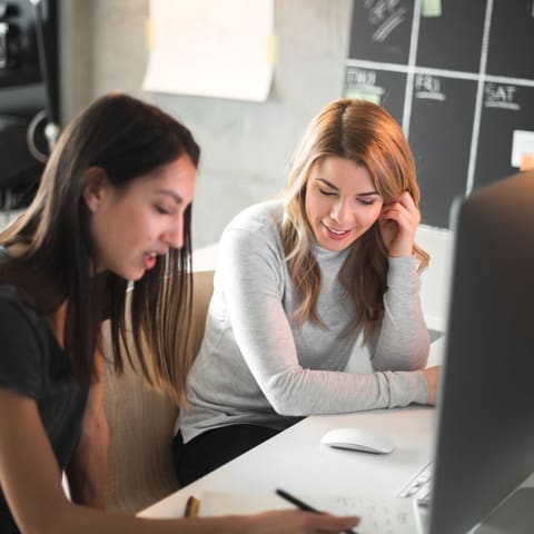 Two web designers reviewing a website design on a computer